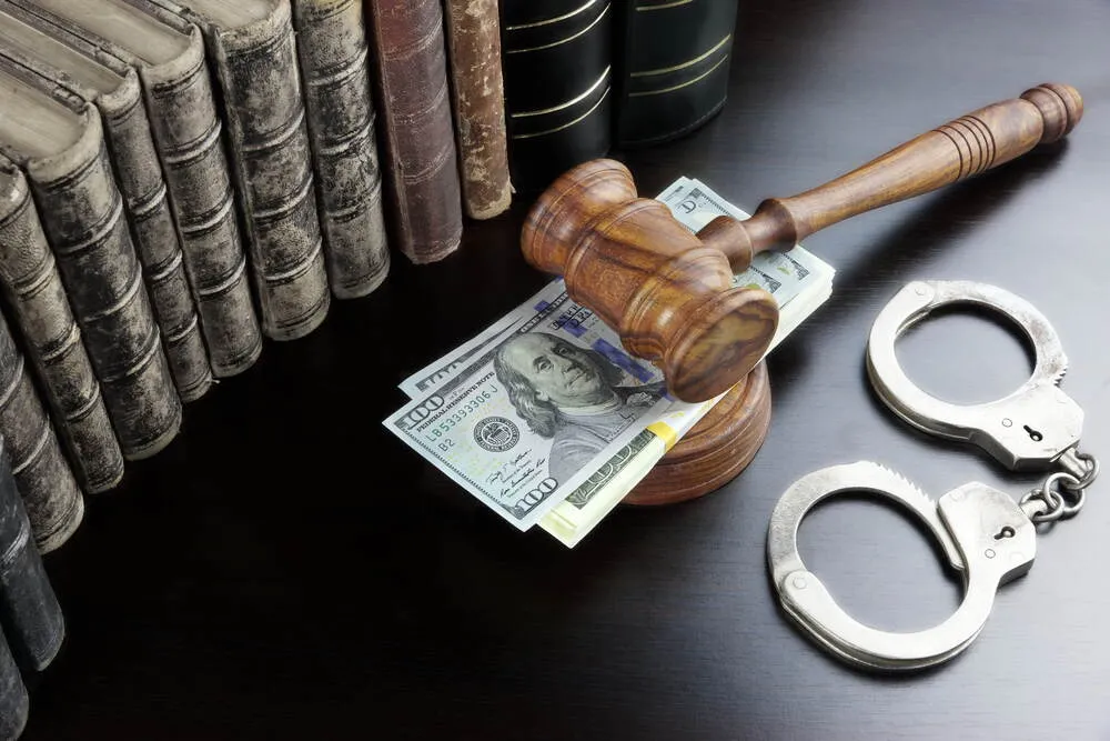 Judges Gavel, Handcuffs, Dollar Cash And Old Law Book